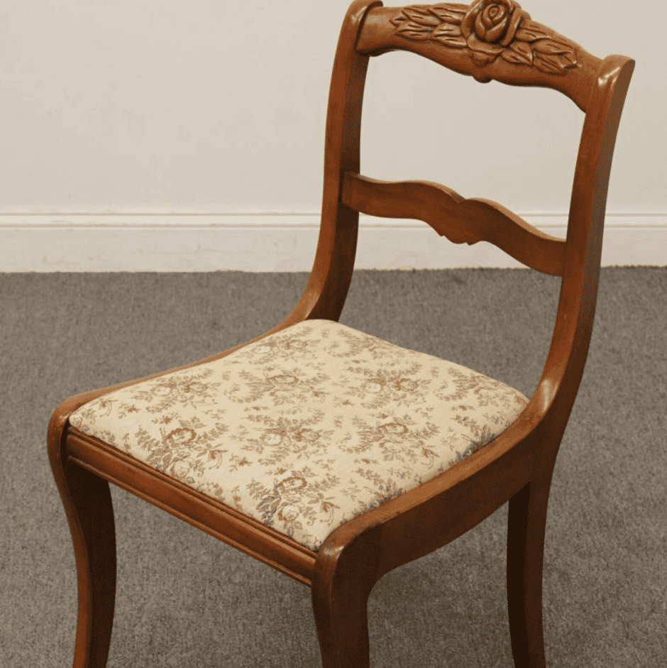 Wooden chair with floral upholstery.