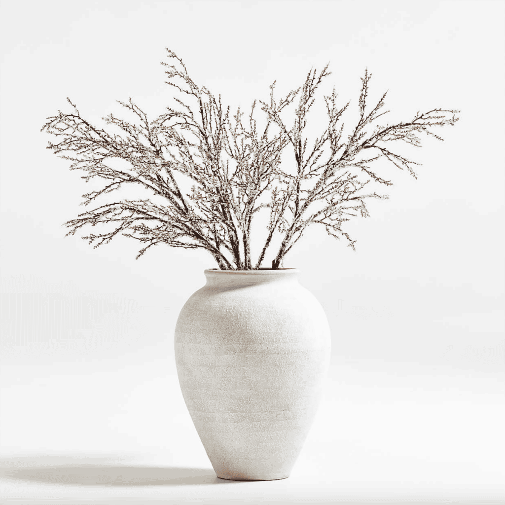 White, matte vase filled with branches.