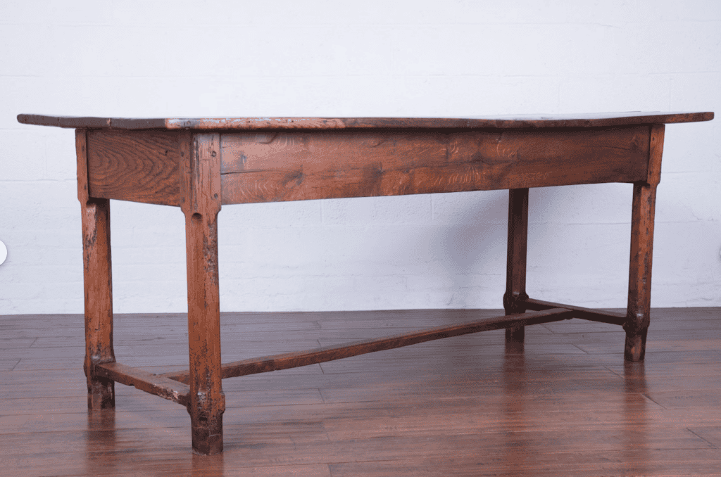 Antique farm table on a wooden floor.