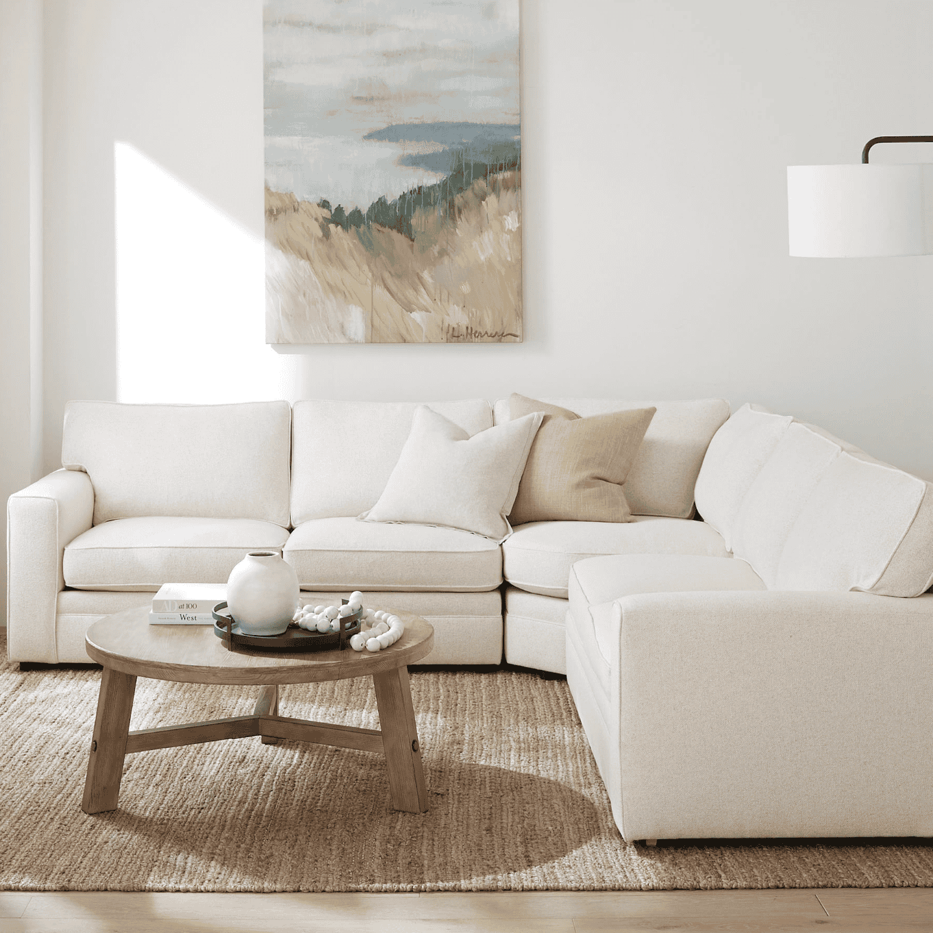 Round coffee table by a white sofa.