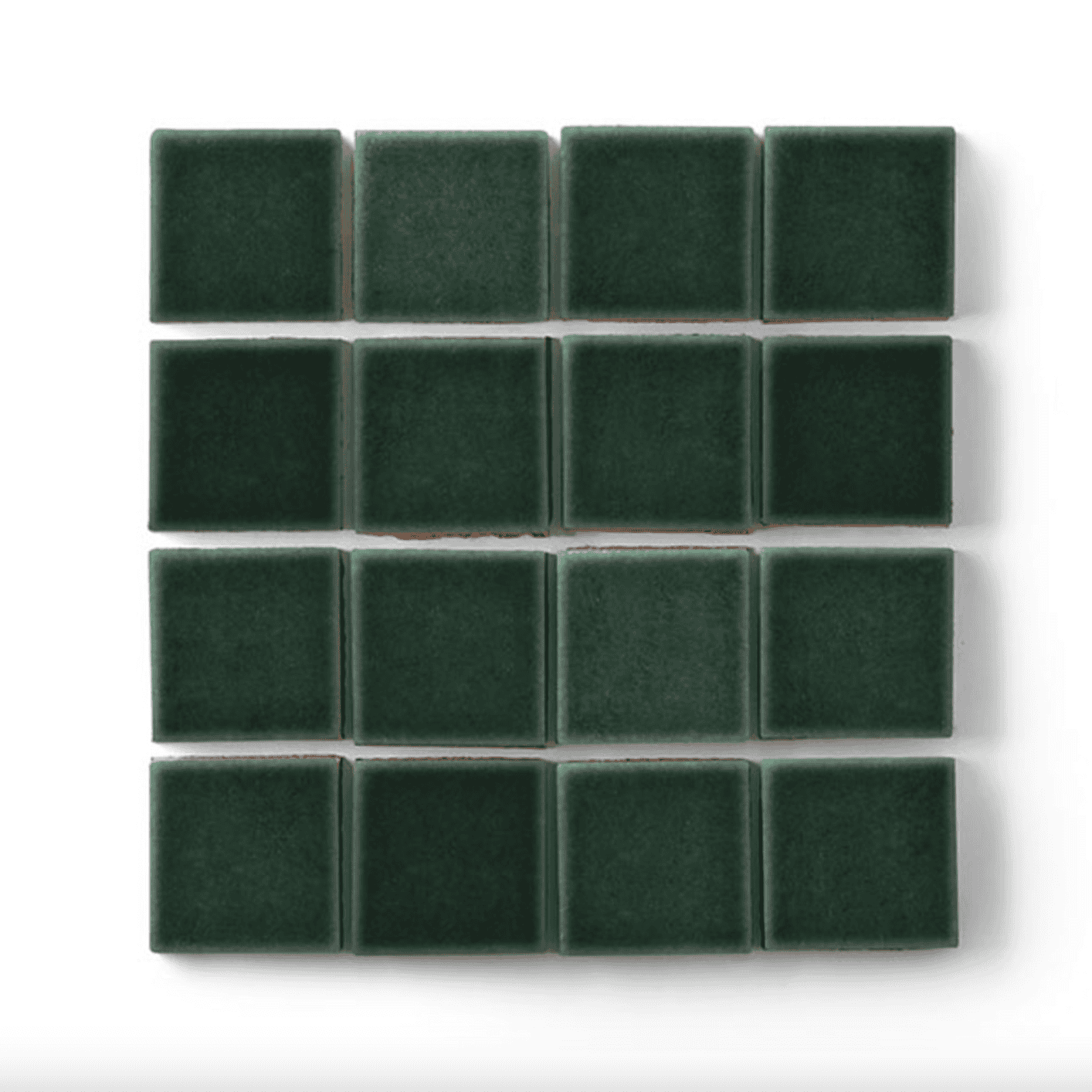 Evergreen-colored tiles on a white surface.