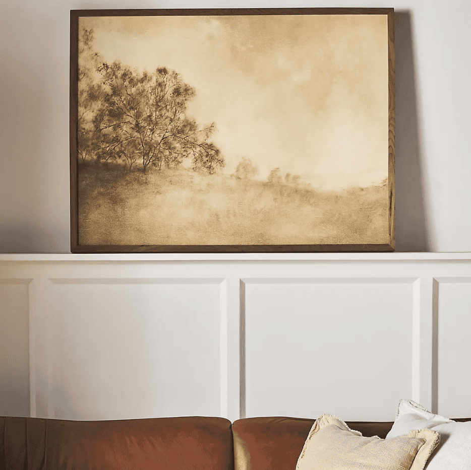Neutral-colored wall art on a shelf.