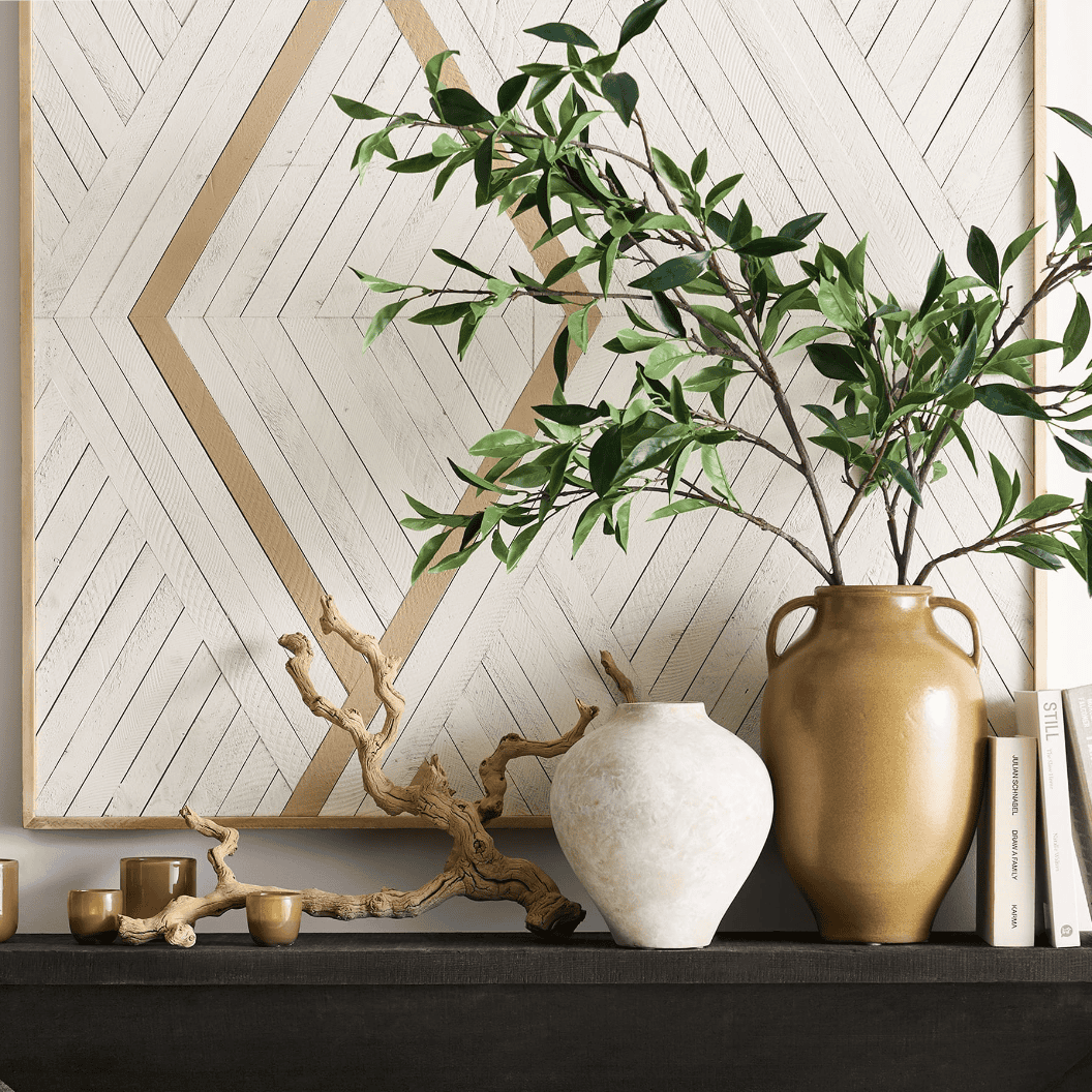 Fake green branch in a golden vase.