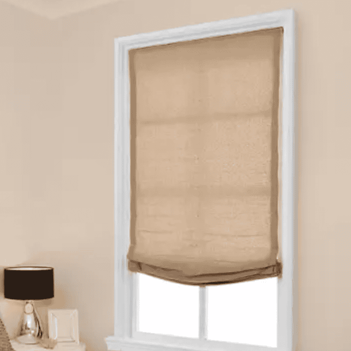 Fabric window shade over a bright window.