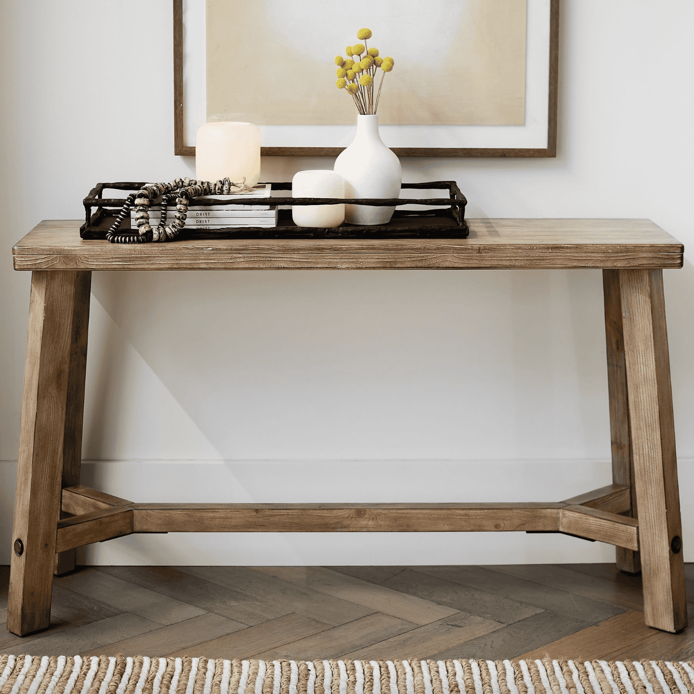 Wooden console table topped with a tray.