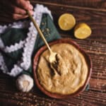 miso mayo on a fork with seeds and lemons on a wooden table