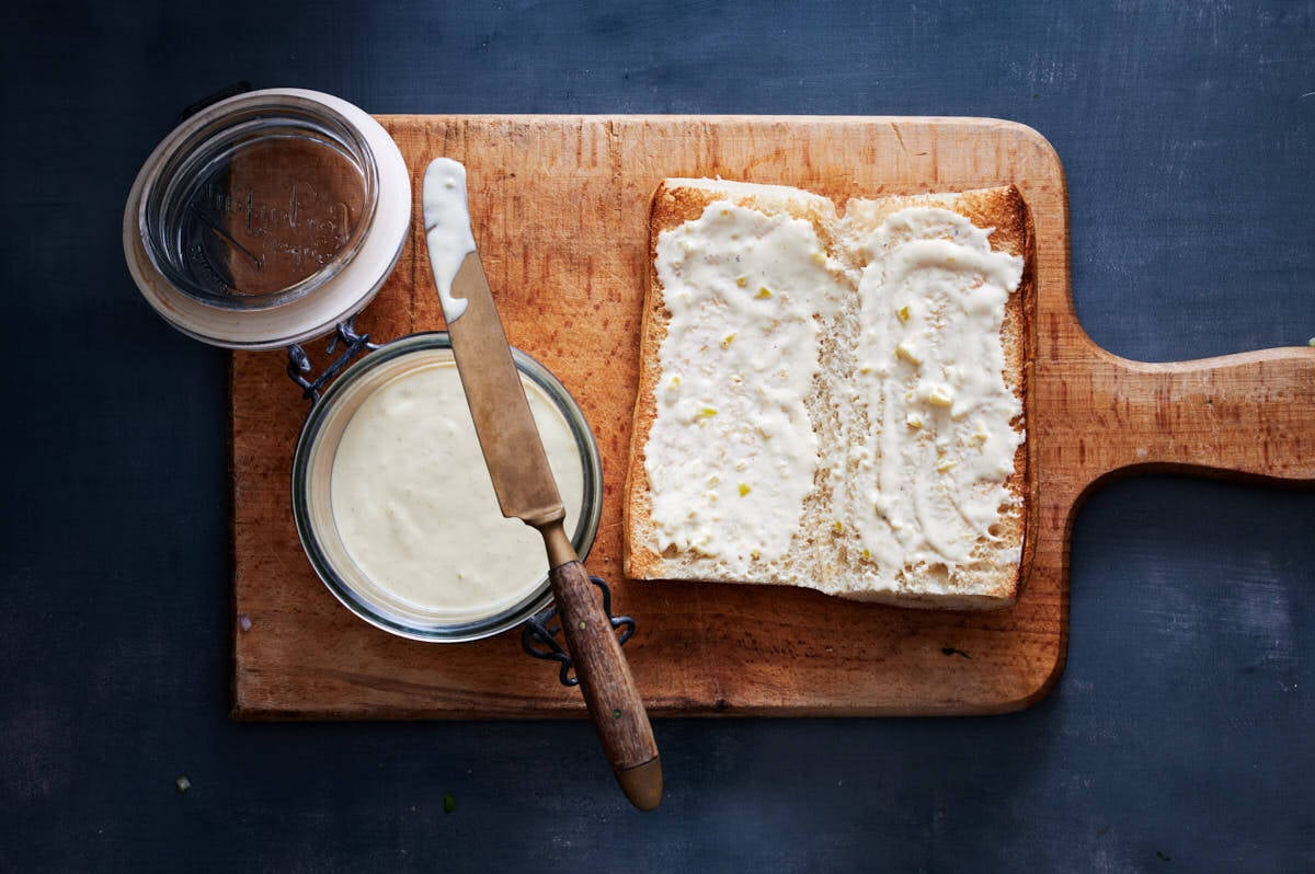 fresh baked chibata bread cut open faced and spread with an aioli. 