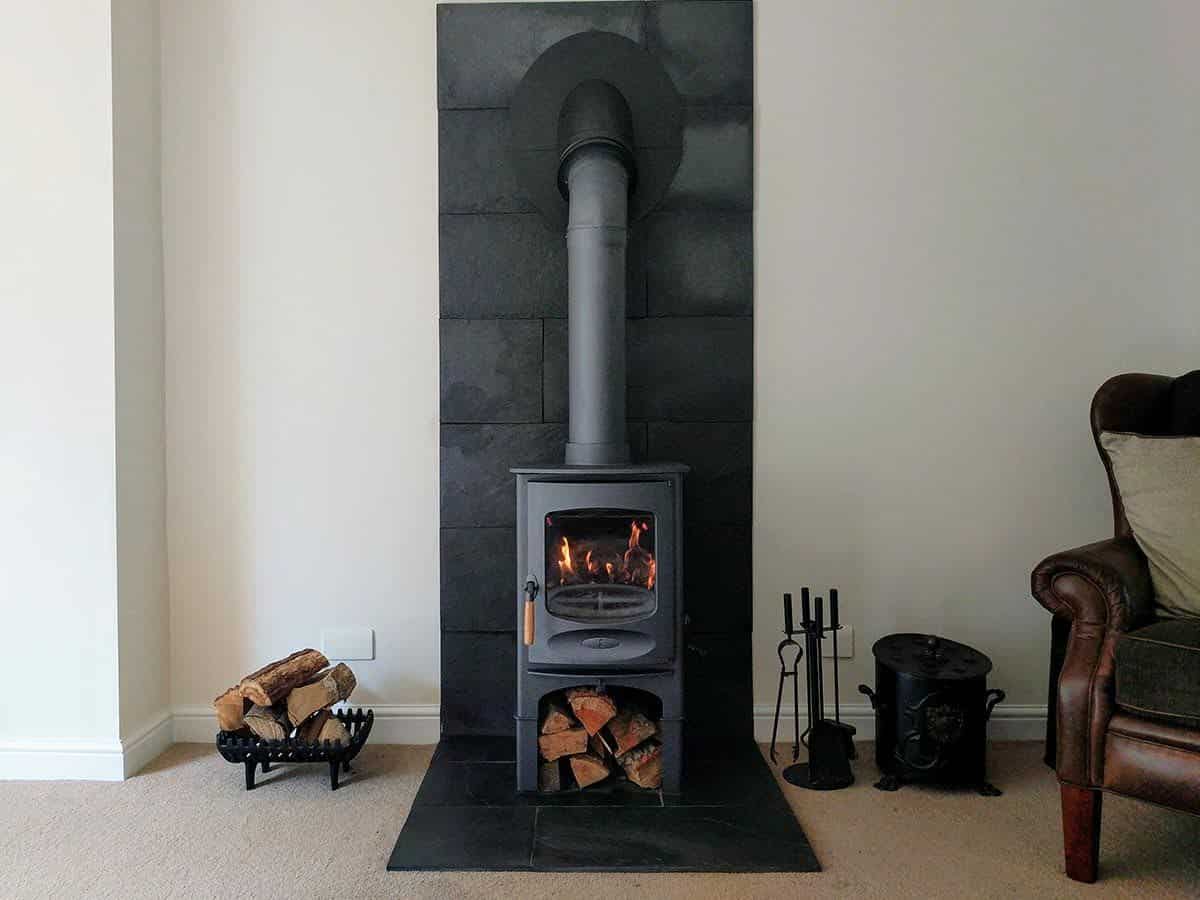 Restored modern cabin interior featuring the best wood stove for cabin heating during cold winter months.

