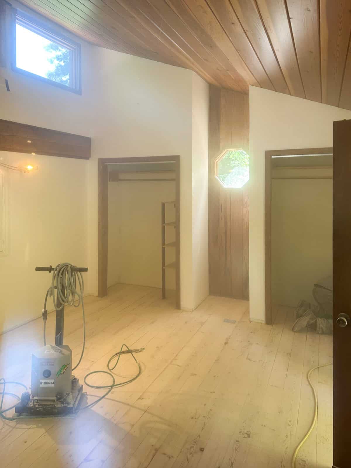 pine floors being sanded in real time with a belt sander and dust.
