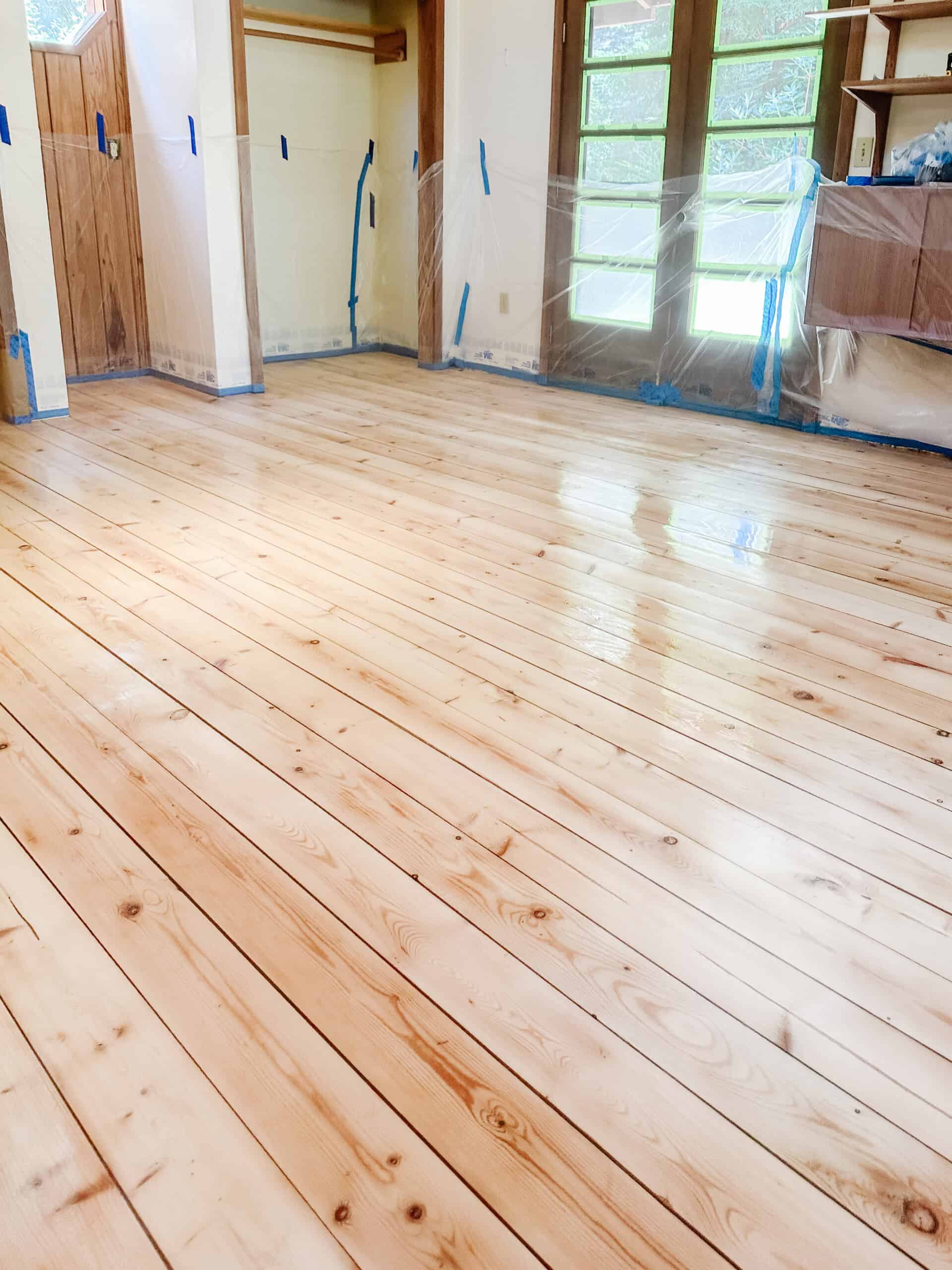 three coats of masters armor is wet and curing on freshly sanded hardood pine floors in the cabin bedroom loft looking shiny.