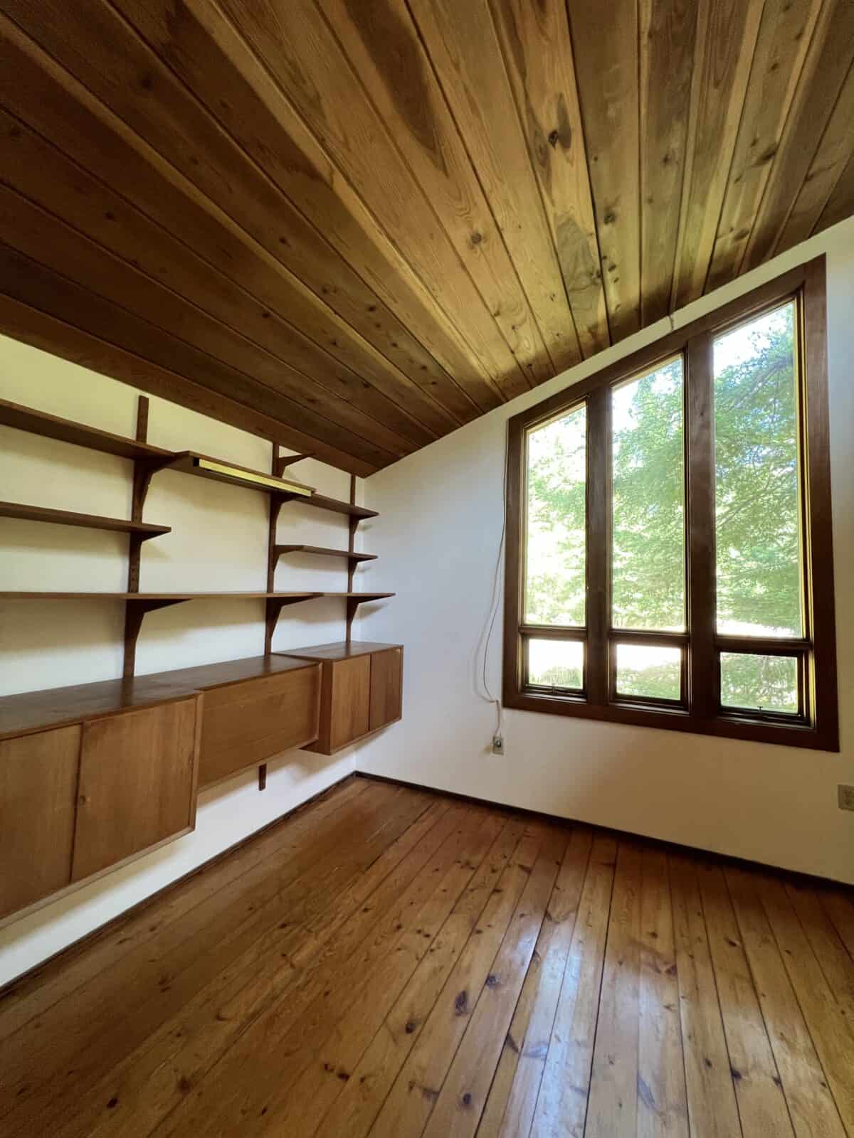dark damaged hardwood pine  floors before sanding them to a light finish.