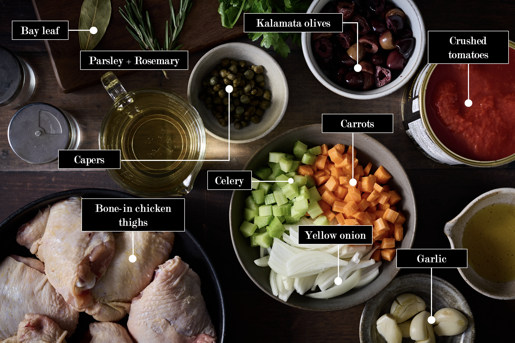 Pollo alla cacciatora ingredients on a table with diced onion, carrots, celery, oil, white wine, garlic, and finishing herbs.