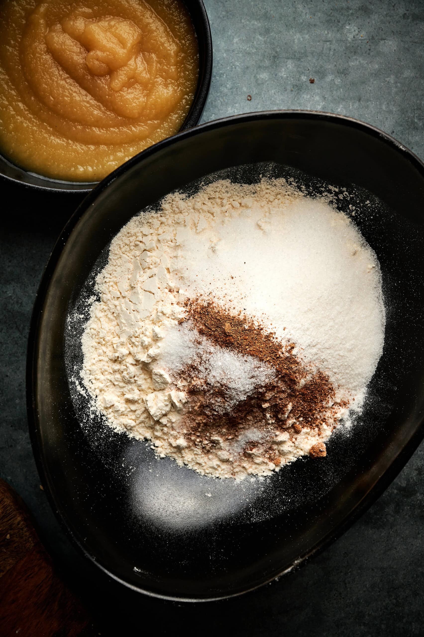 flour, sugar, baking powder, cinnamon, nutmeg, and a pinch of salt in a bowl to make applesauce fritters.