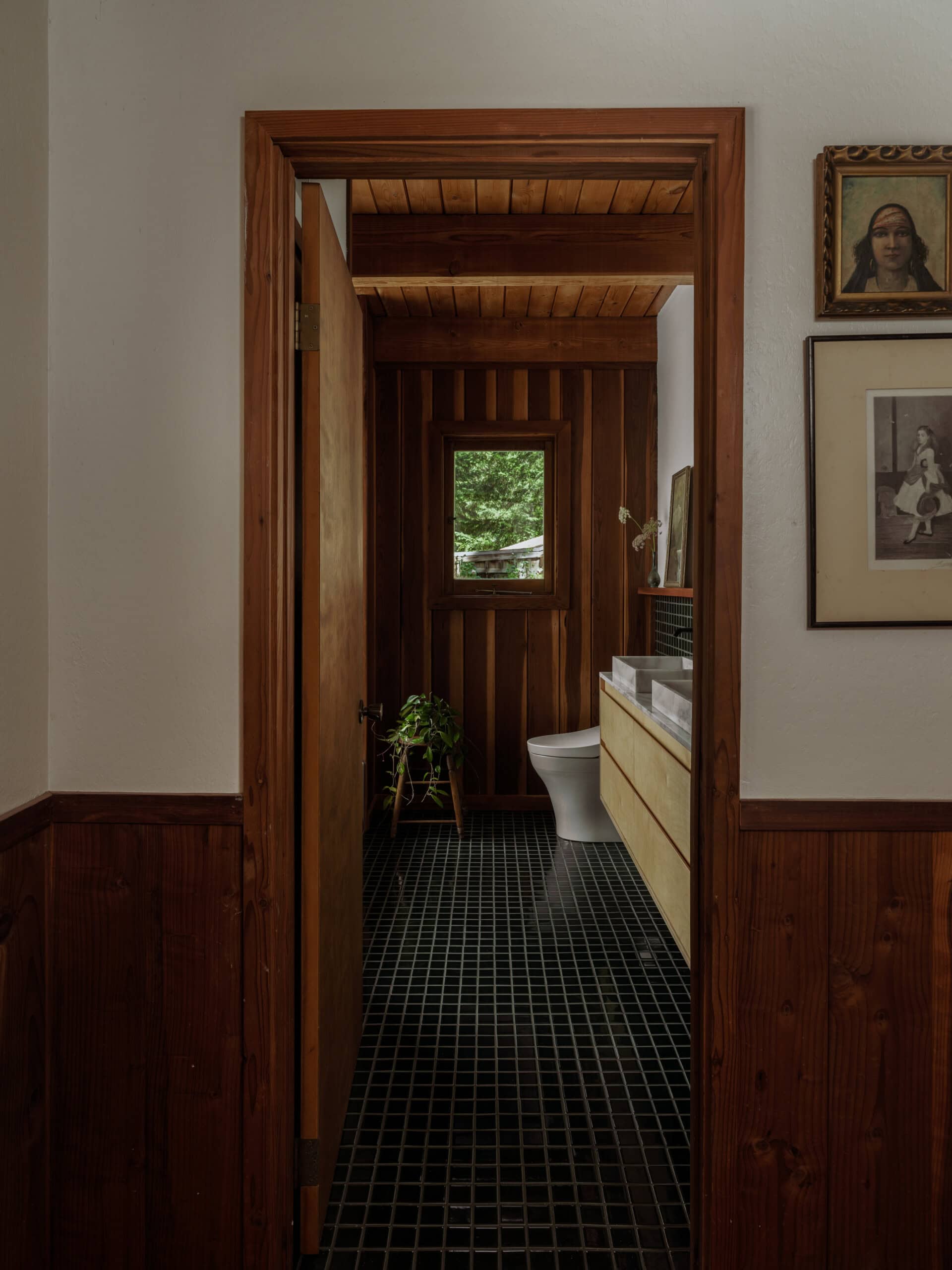 a new image of the bathroom with new tile and restored walls and redwood paneling. 