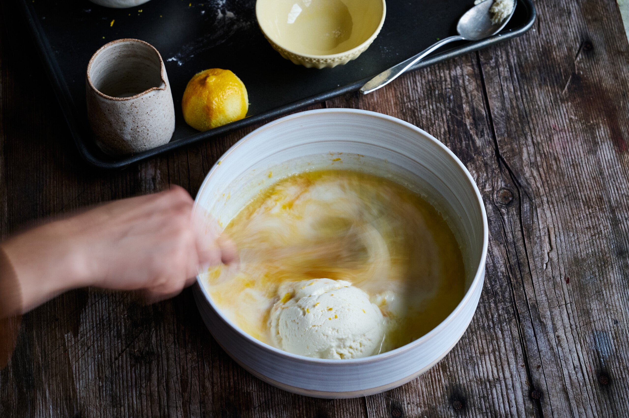 Wet ingredients for lemon and ricotta panckaes being mixed ina bowl.