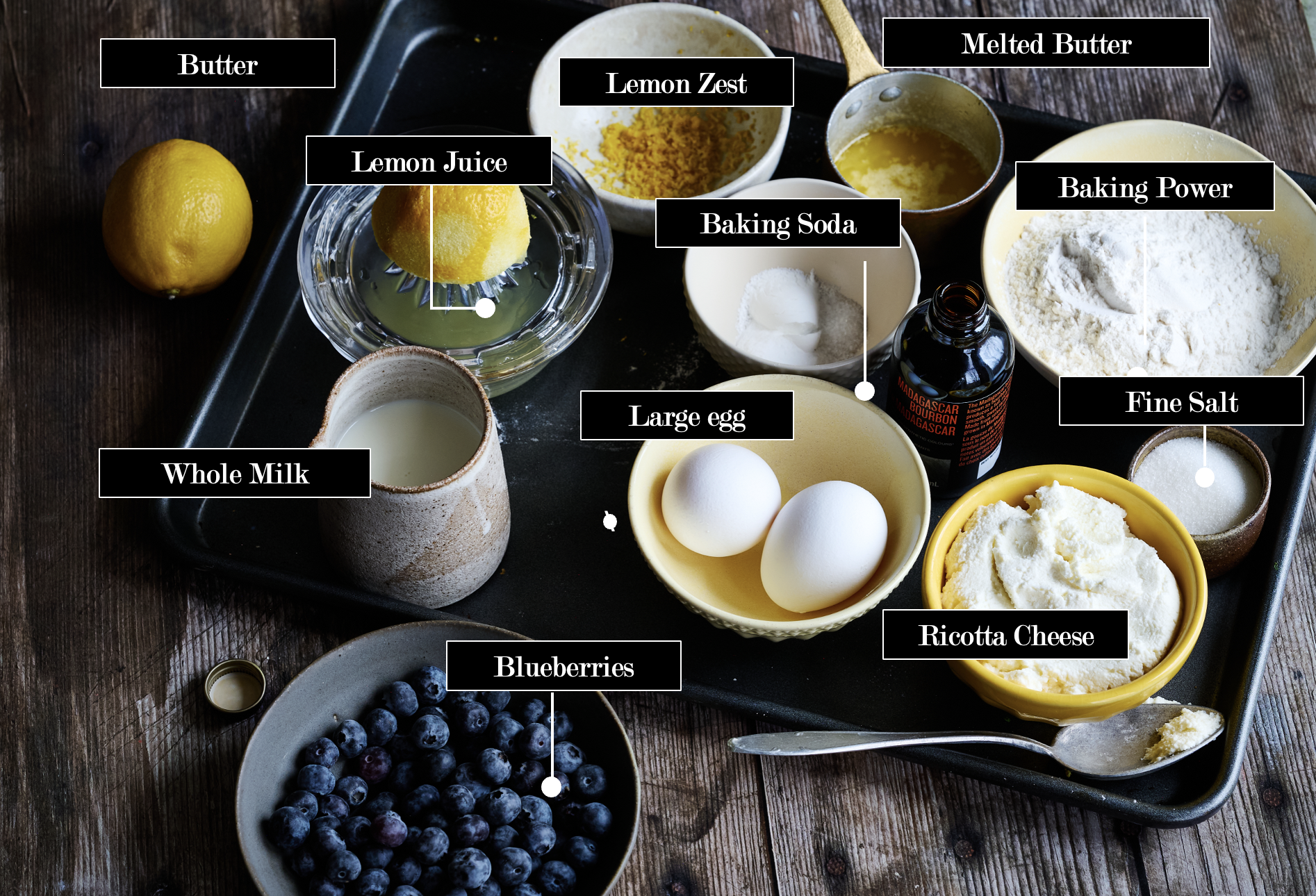 Lemon and Ricotta Pancakes ingredients on a table including; butter, baking soda, powder, sugar, eggs, and sugar