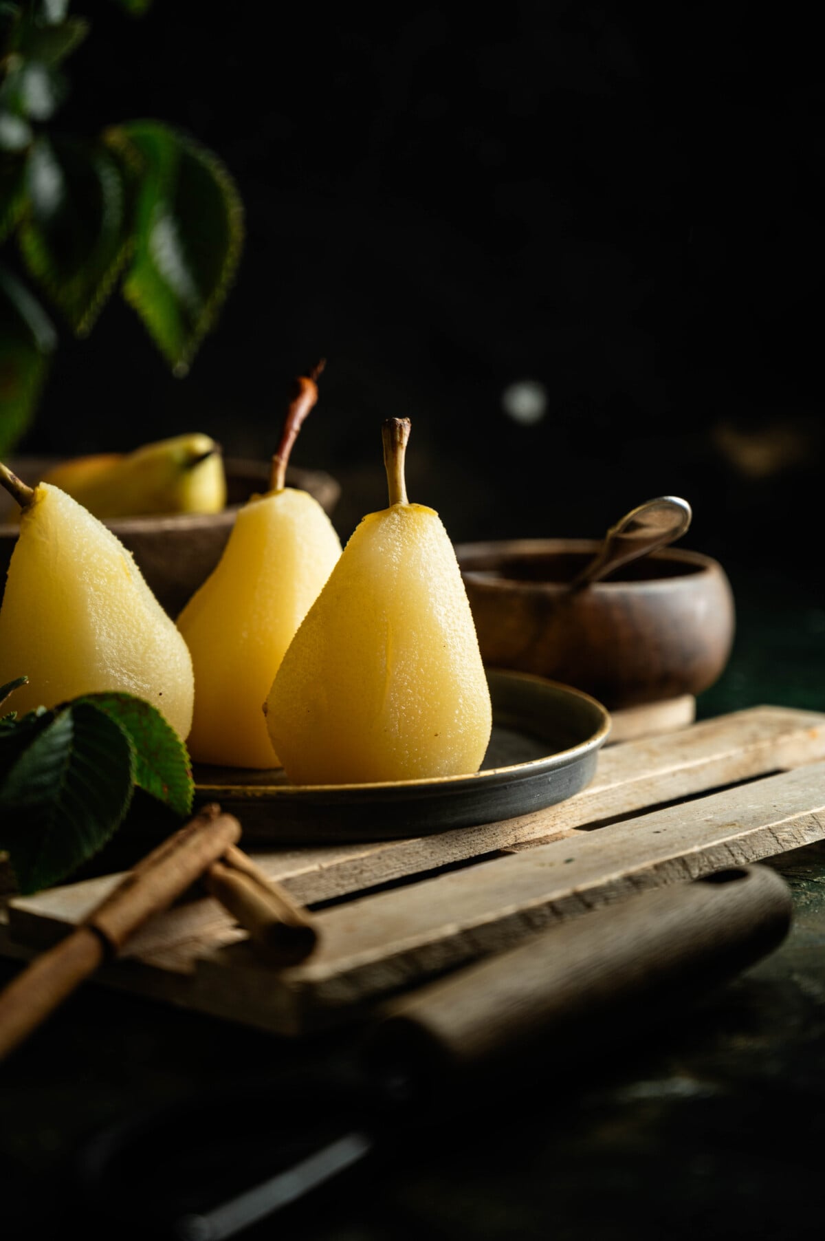 Easy poached pears recipe served with spiced poaching syrup and fresh fruit.