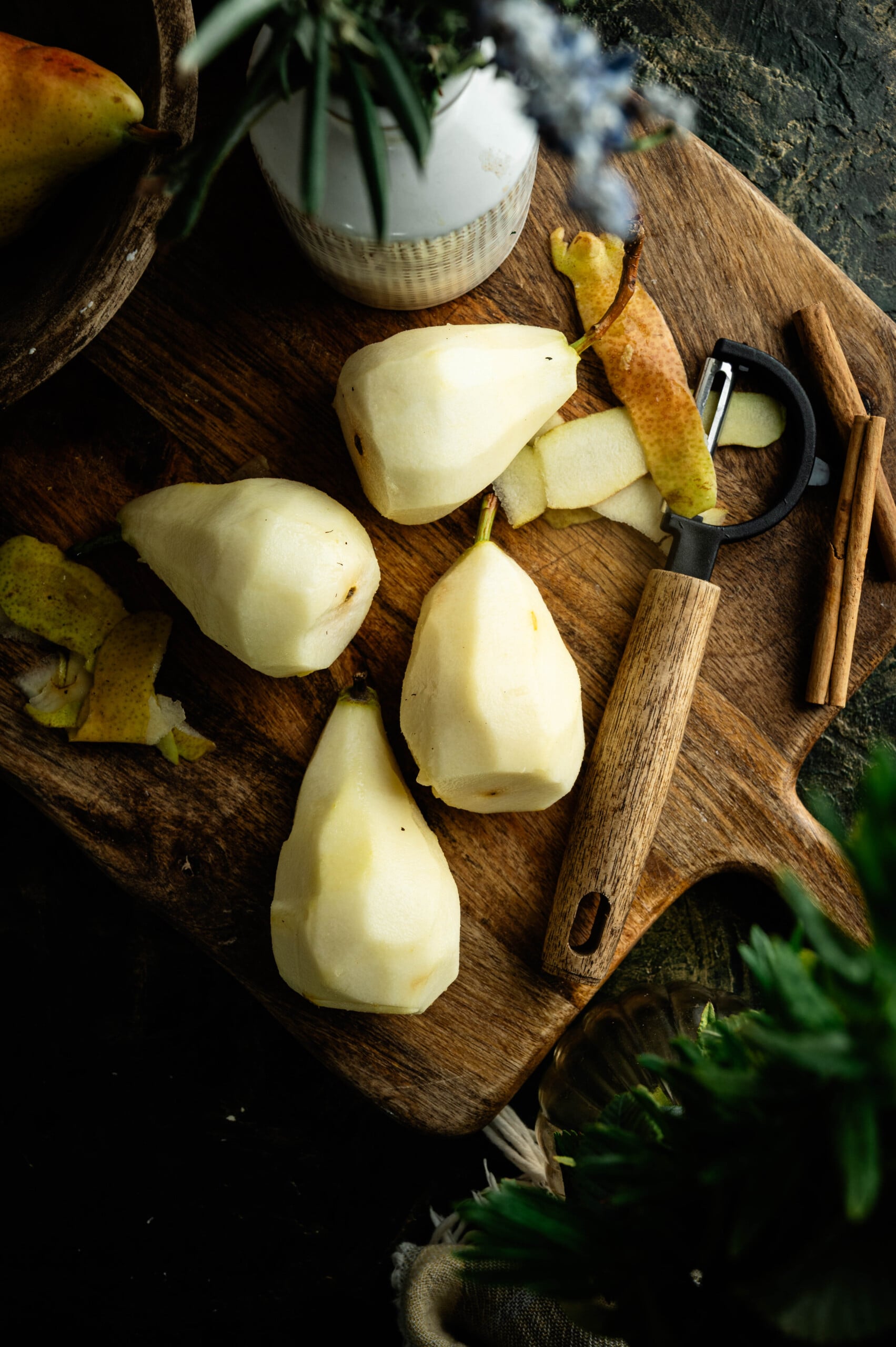 Peeled pears with stems attached ready for poaching.
