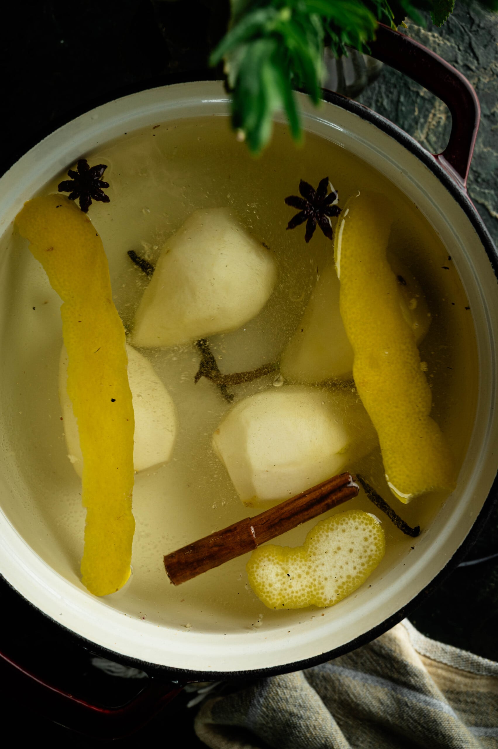 ears gently simmering in flavored poaching liquid on the stove.